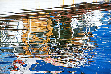 Image showing reflection of a boat in a port