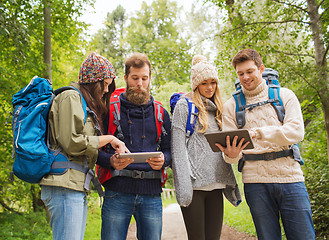 Image showing group of friends with backpacks and tablet pc