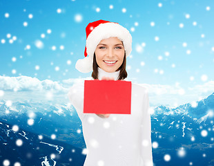Image showing woman in santa helper hat with blank red card