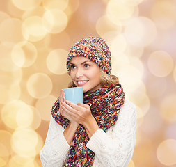 Image showing smiling young woman in winter clothes with cup