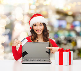 Image showing smiling woman with credit card and laptop