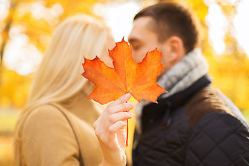 Image showing close up of couple kissing in autumn park