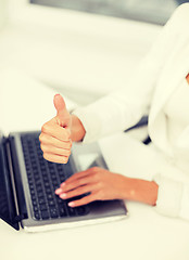 Image showing businesswoman with laptop showing thumbs up