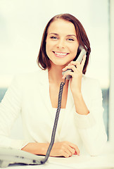 Image showing businesswoman with rotary phone calling