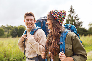 Image showing smiling couple with backpacks hiking