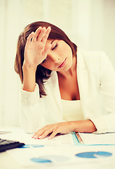 Image showing bored and tired woman with documents