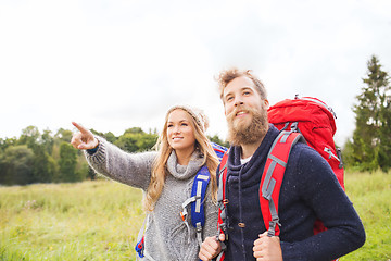 Image showing smiling couple with backpacks hiking