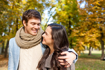 Image showing smiling couple hugging in autumn park