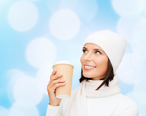 Image showing smiling young woman in winter clothes with cup