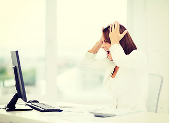 Image showing stressed woman with computer