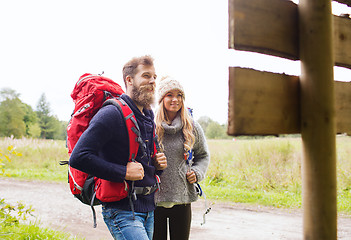 Image showing smiling couple with backpacks hiking