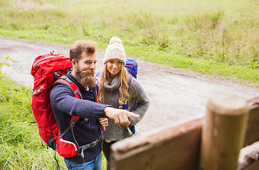 Image showing smiling couple with backpacks hiking