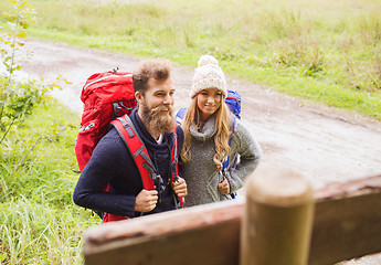 Image showing smiling couple with backpacks hiking