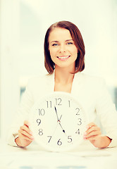 Image showing attractive businesswoman with white clock