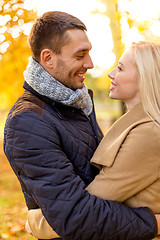 Image showing smiling couple hugging in autumn park