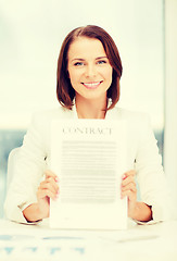 Image showing happy businesswoman holding contract