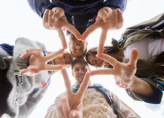 Image showing group of smiling friends with backpacks hiking