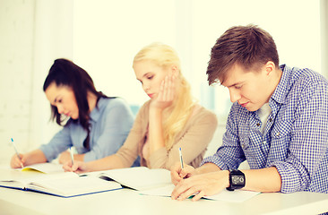 Image showing tired students with notebooks at school