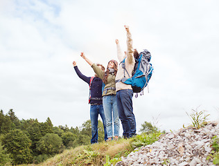 Image showing group of smiling friends with backpacks hiking