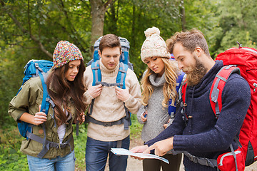 Image showing group of smiling friends with backpacks hiking