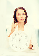 Image showing attractive businesswoman with white clock