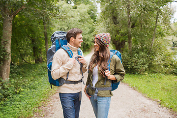 Image showing smiling couple with backpacks hiking