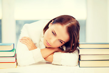 Image showing tired student with books and notes