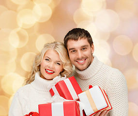 Image showing smiling man and woman with presents