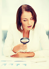 Image showing businesswoman working with graphs in office