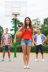 Image showing group of smiling teenagers playing basketball