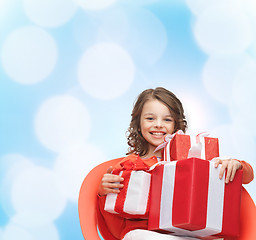 Image showing smiling little girl with gift boxes