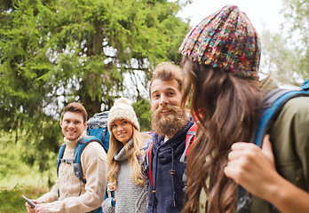 Image showing group of friends with backpacks and tablet pc