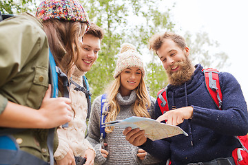 Image showing group of smiling friends with backpacks hiking