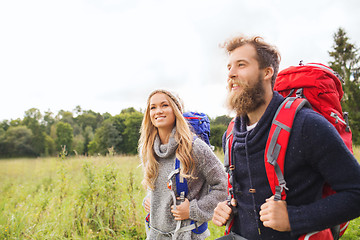 Image showing smiling couple with backpacks hiking