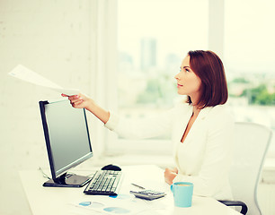 Image showing businesswoman giving papers in office