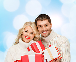 Image showing smiling man and woman with presents