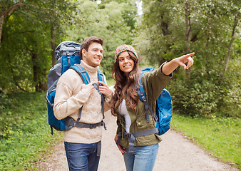 Image showing smiling couple with backpacks hiking