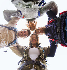 Image showing group of smiling friends with backpacks hiking