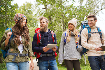 Image showing group of friends with backpacks and tablet pc
