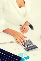 Image showing woman hand with calculator and papers