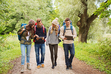 Image showing group of friends with backpacks and tablet pc