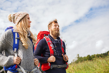 Image showing smiling couple with backpacks hiking