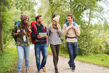 Image showing group of smiling friends with backpacks hiking