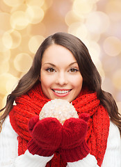 Image showing smiling woman in winter clothes with snowball