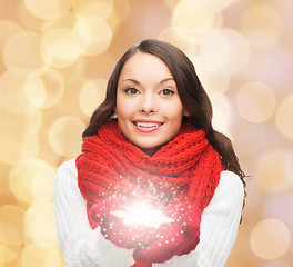 Image showing smiling woman in winter clothes with snowflake