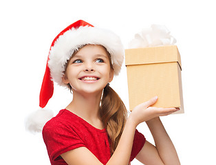 Image showing smiling girl in santa helper hat with gift box