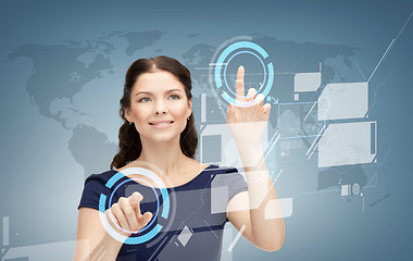 Image showing smiling businesswoman working with virtual screen