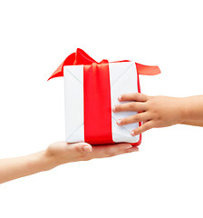 Image showing close up of child and mother hands with gift box