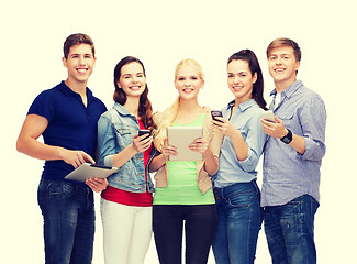 Image showing smiling students using smartphones and tablet pc