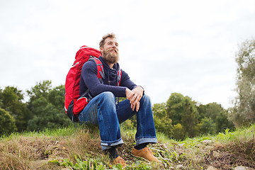 Image showing smiling man with backpack hiking